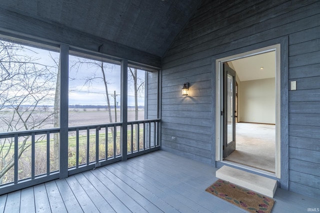 unfurnished sunroom with a healthy amount of sunlight and vaulted ceiling