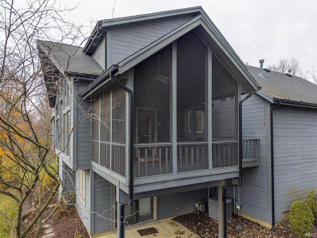 view of home's exterior with a sunroom and cooling unit