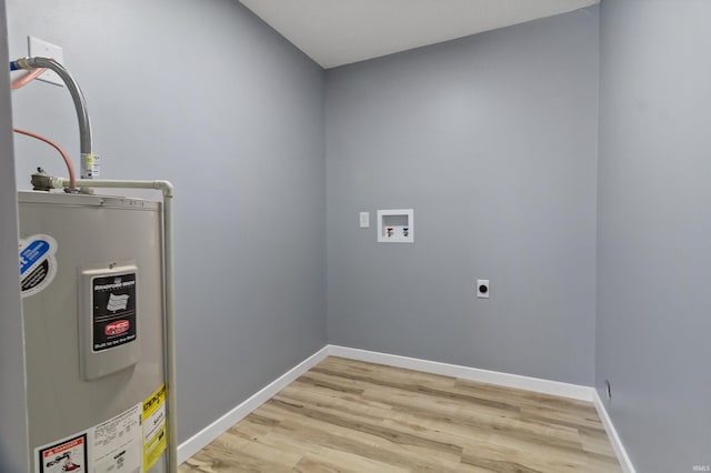 clothes washing area featuring hookup for an electric dryer, hookup for a washing machine, light hardwood / wood-style flooring, and water heater