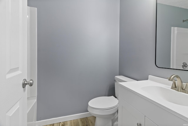 bathroom featuring hardwood / wood-style floors, vanity, and toilet