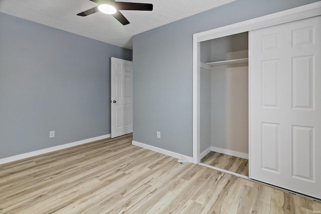 unfurnished bedroom featuring ceiling fan, a closet, and light hardwood / wood-style floors