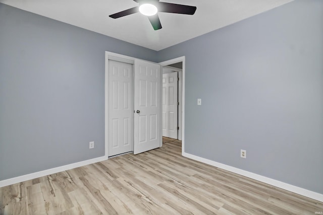 unfurnished bedroom featuring ceiling fan, a closet, and light hardwood / wood-style floors