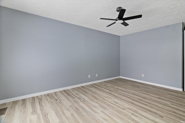 unfurnished room with light wood-type flooring, a textured ceiling, and ceiling fan