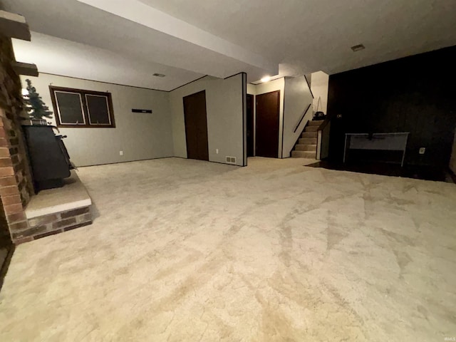 carpeted living room featuring a brick fireplace