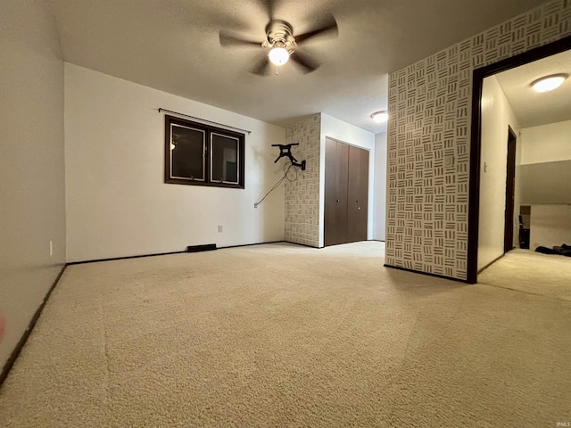 carpeted empty room with ceiling fan