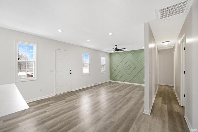 foyer entrance featuring wood-type flooring and ceiling fan