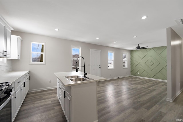 kitchen featuring white cabinets, a kitchen island with sink, sink, and a wealth of natural light