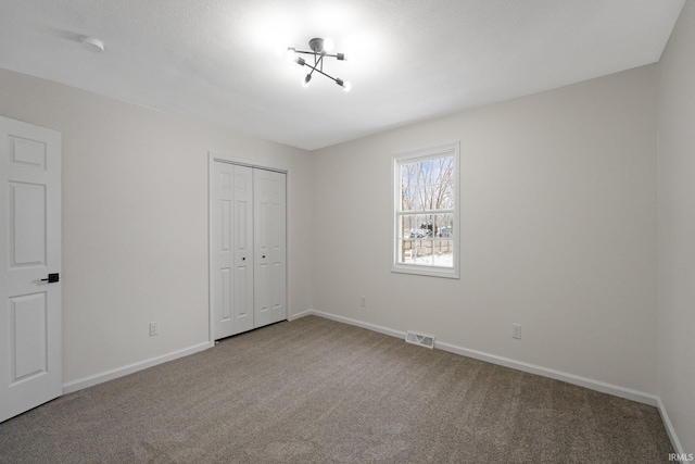 unfurnished bedroom with carpet and a closet