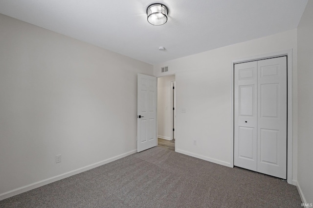 unfurnished bedroom with carpet floors and a closet