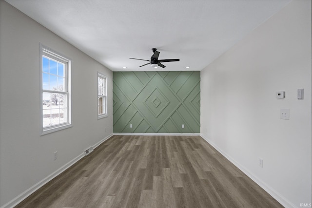 spare room featuring wood-type flooring and ceiling fan