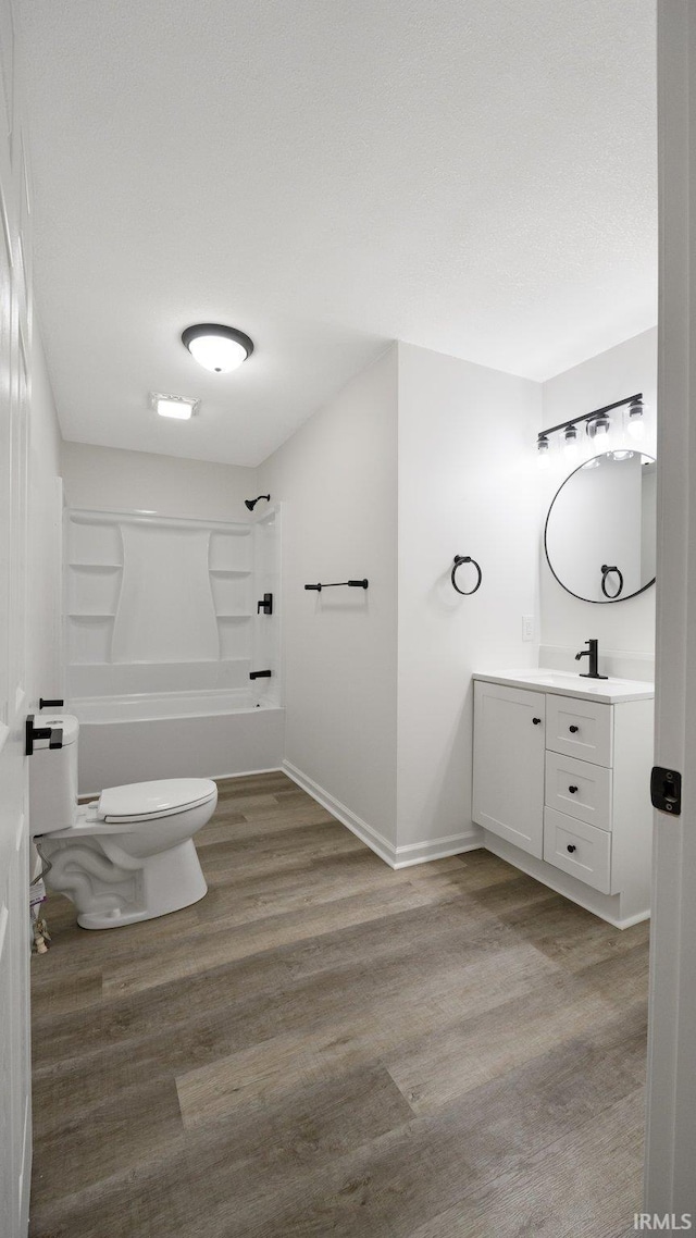 full bathroom featuring wood-type flooring, vanity, toilet, and  shower combination