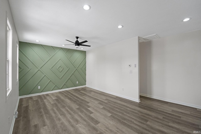 spare room featuring wood-type flooring and ceiling fan