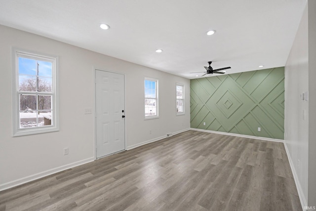 foyer entrance with ceiling fan and hardwood / wood-style flooring