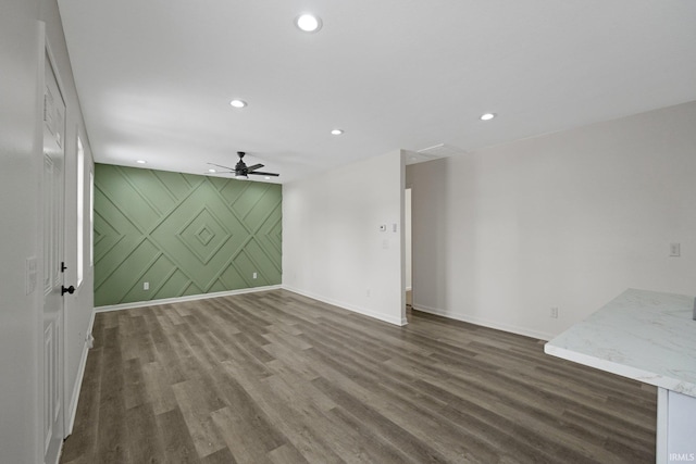 spare room with dark hardwood / wood-style flooring and ceiling fan