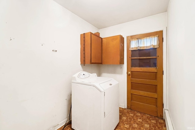 clothes washing area featuring baseboard heating, washer / clothes dryer, and cabinets