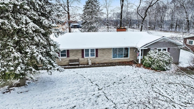 view of snow covered rear of property