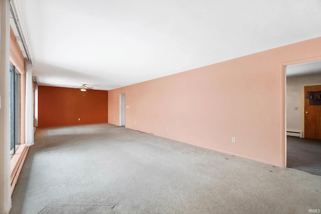 unfurnished room featuring baseboard heating, ceiling fan, and light colored carpet