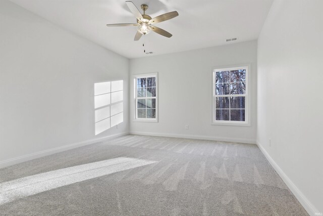 spare room featuring ceiling fan and light colored carpet