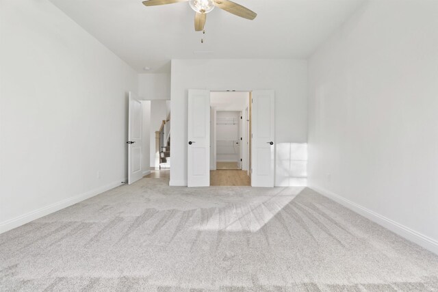 unfurnished bedroom featuring ceiling fan and light colored carpet