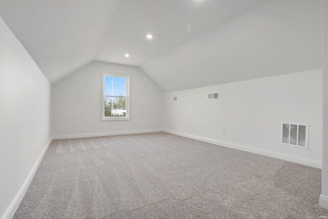 bonus room featuring carpet flooring and lofted ceiling