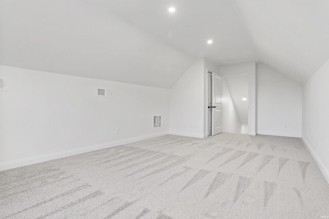 bonus room featuring light carpet and lofted ceiling