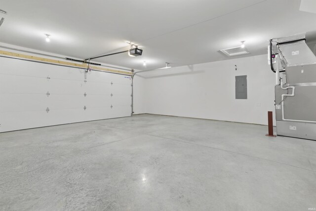 garage featuring electric panel, a garage door opener, and heating unit