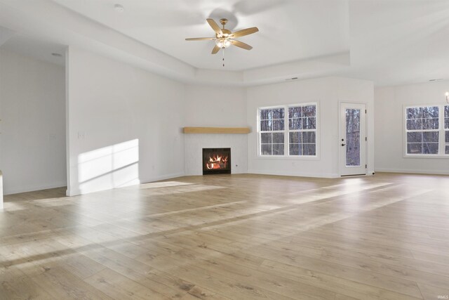 unfurnished living room featuring light wood-type flooring and ceiling fan