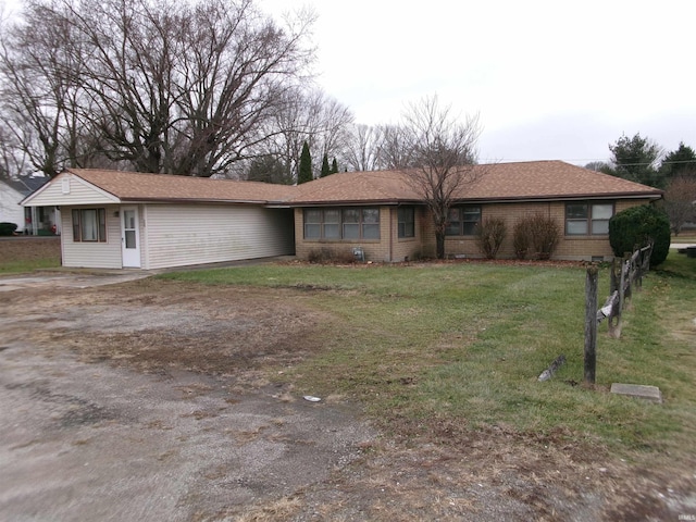 ranch-style home featuring a front yard