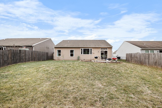 back of house featuring a lawn and a patio area