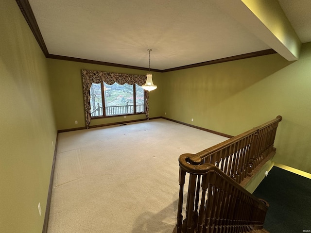 carpeted spare room with crown molding