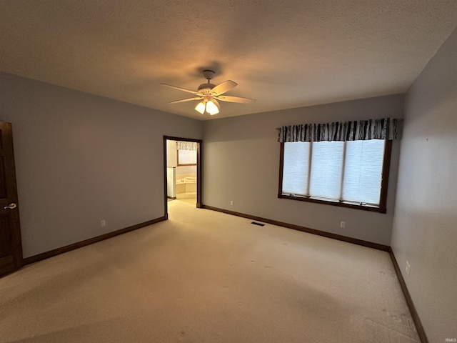 empty room featuring light carpet and ceiling fan