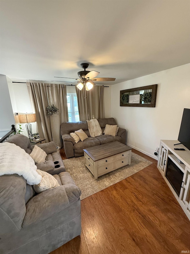 living room with ceiling fan and wood-type flooring