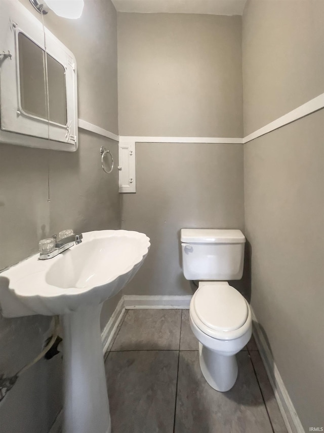 bathroom featuring tile patterned flooring and toilet