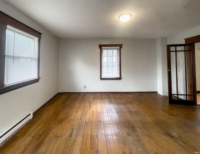 spare room featuring dark hardwood / wood-style floors and baseboard heating