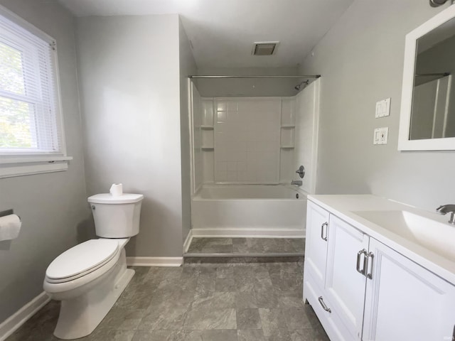 full bathroom featuring vanity, a healthy amount of sunlight, toilet, and tiled shower / bath combo