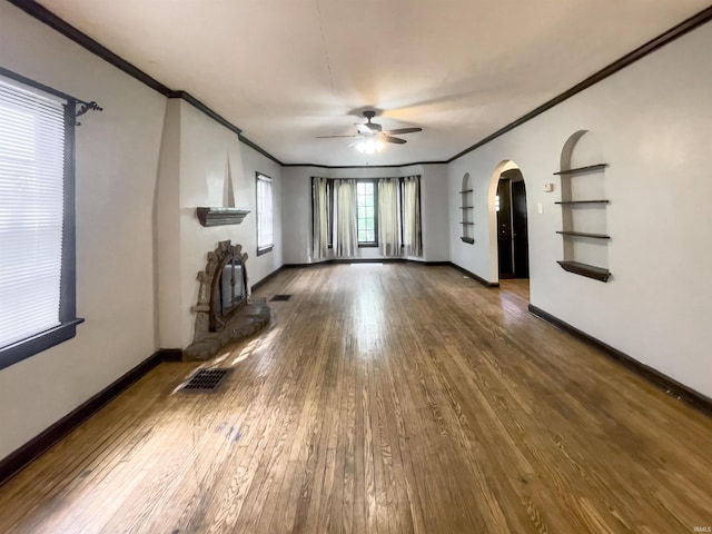 unfurnished living room featuring ceiling fan, wood-type flooring, and crown molding