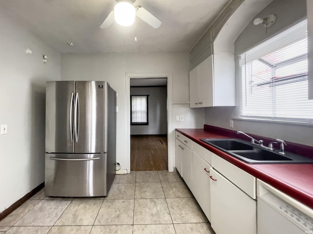 kitchen with stainless steel fridge, ceiling fan, light tile patterned floors, dishwasher, and white cabinets