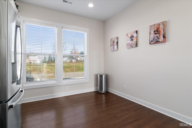 empty room with dark hardwood / wood-style flooring