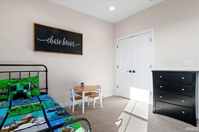 bedroom with carpet and a closet