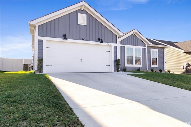 view of front of home with central AC, a front lawn, and a garage