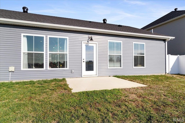 back of house featuring a yard and a patio