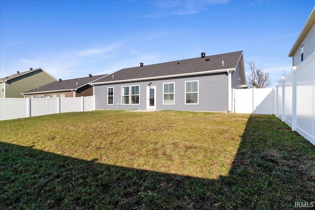 rear view of house with a yard