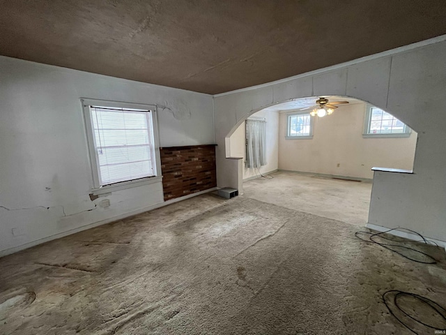 interior space featuring light colored carpet and ceiling fan