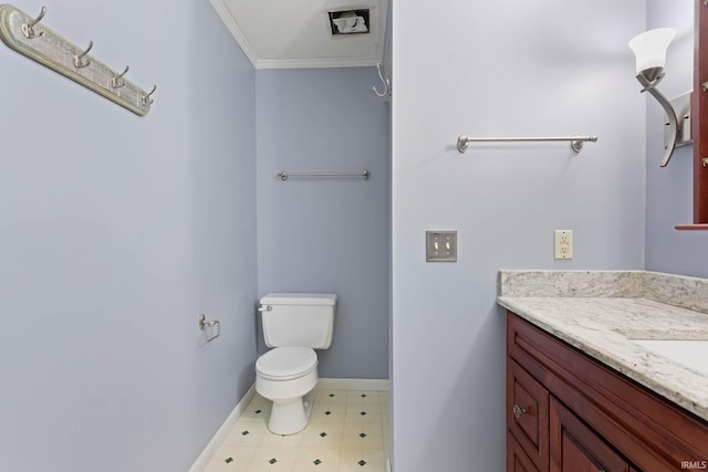 bathroom with vanity, toilet, and ornamental molding