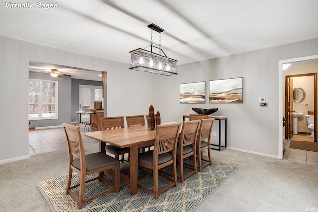 carpeted dining area featuring ceiling fan