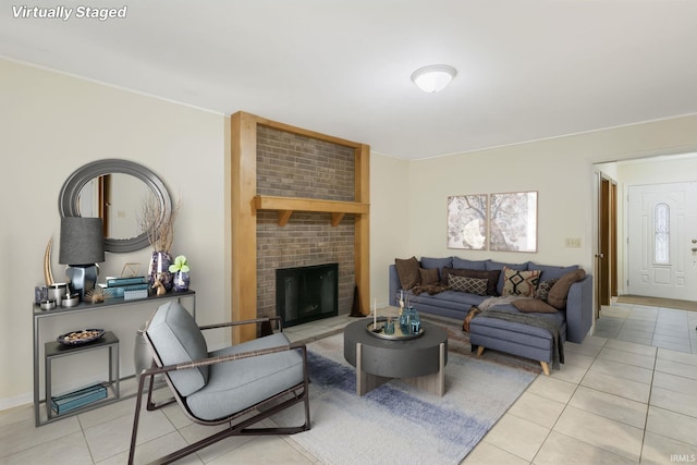 tiled living room featuring a brick fireplace