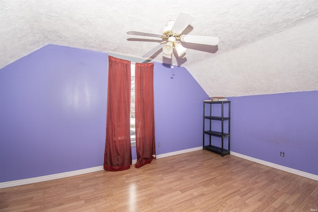 bonus room featuring ceiling fan, wood-type flooring, a textured ceiling, and vaulted ceiling