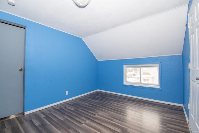 bonus room featuring dark hardwood / wood-style flooring and vaulted ceiling