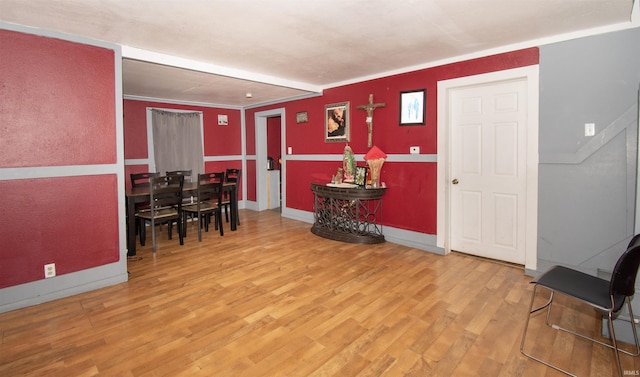 interior space featuring wood-type flooring and ornamental molding