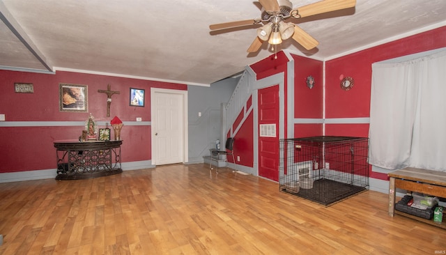 entryway with crown molding, hardwood / wood-style floors, and ceiling fan